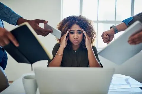 Stressed office worker facing pressure — wondering can I print personal documents at work without issues?